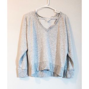 Stretchy, gray, off-shoulder sweatshirt.